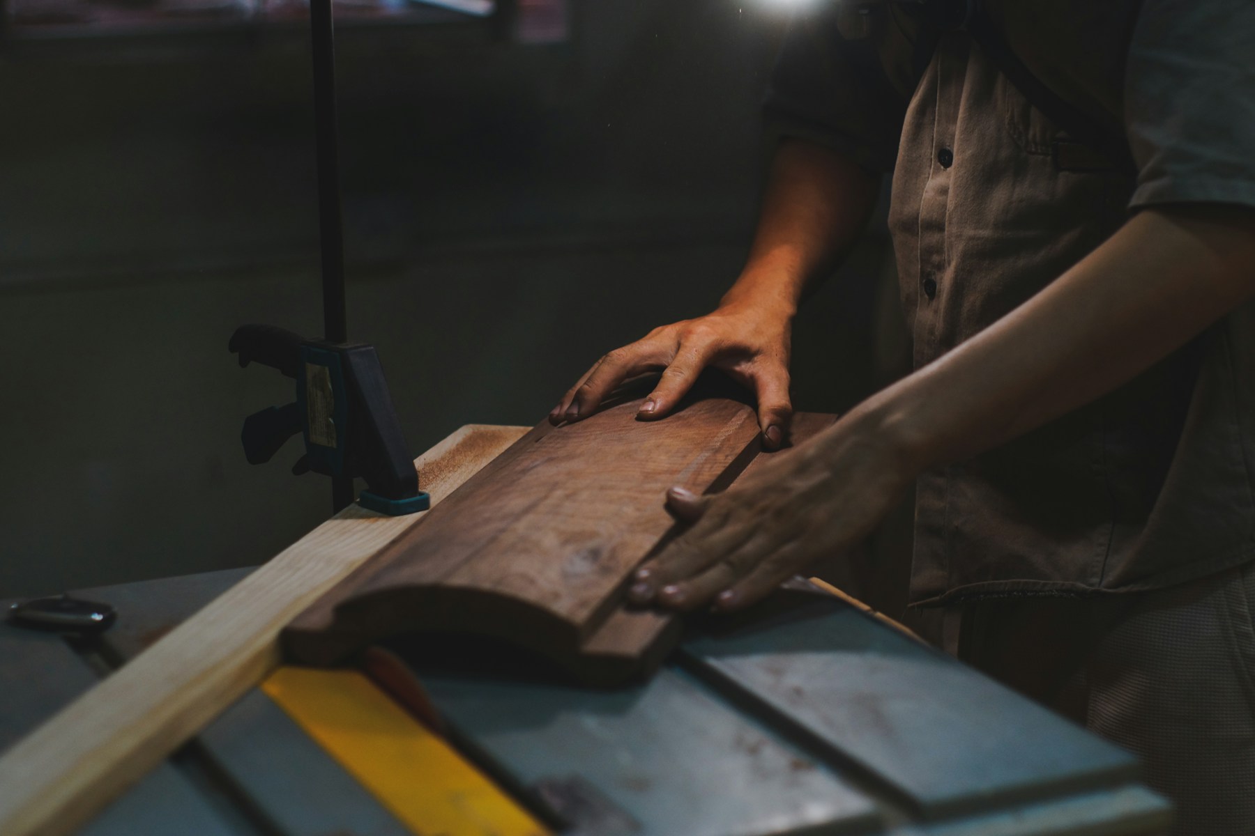 Skilled carpenter making a precise cut in a woodworking shop