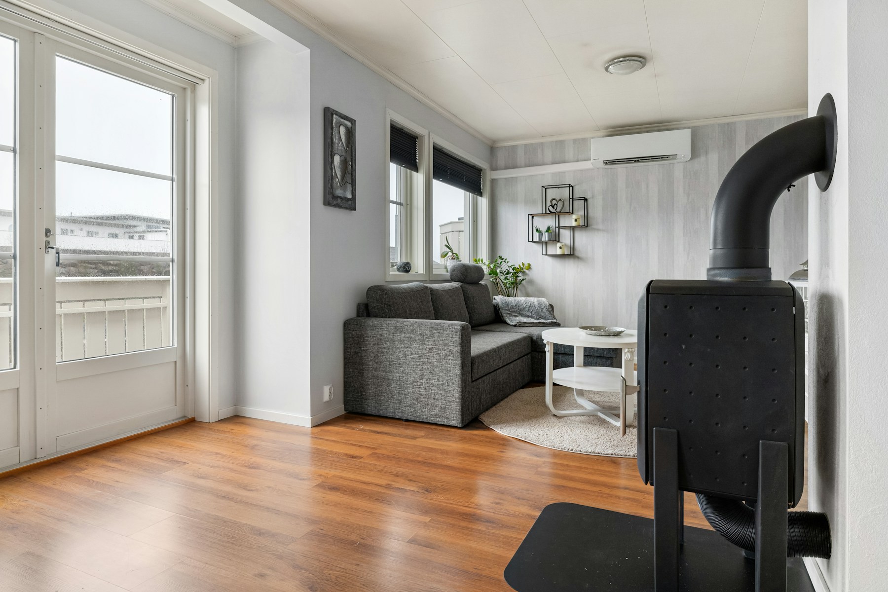Finished living room with rich hardwood flooring and clean white trim